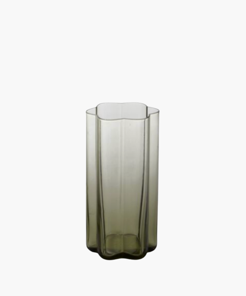 Tall, transparent glass with a unique geometric, wavy-edged design and a subtle green tint, giving a modern and elegant feel against a white background. | Wildwood Home Co.