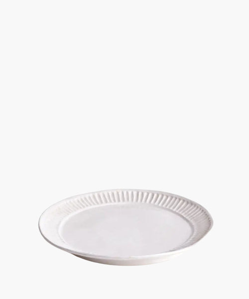 White ceramic plate with decorative rim on a white background