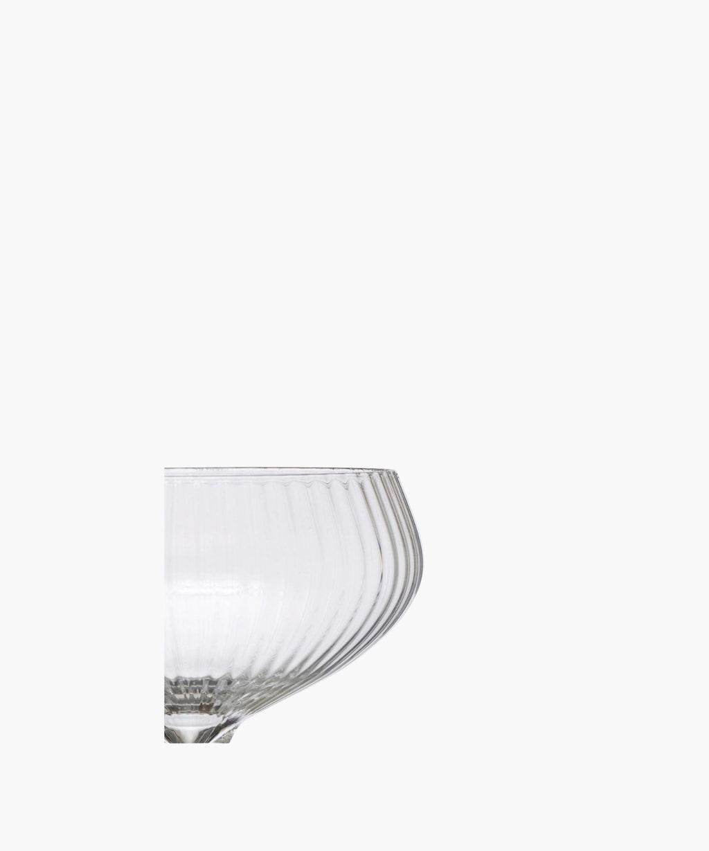 A detailed picture of a clear glass coupe highlighting the vertical ridges. It exudes sophistication and vintage charm. | Wildwood Home Co.